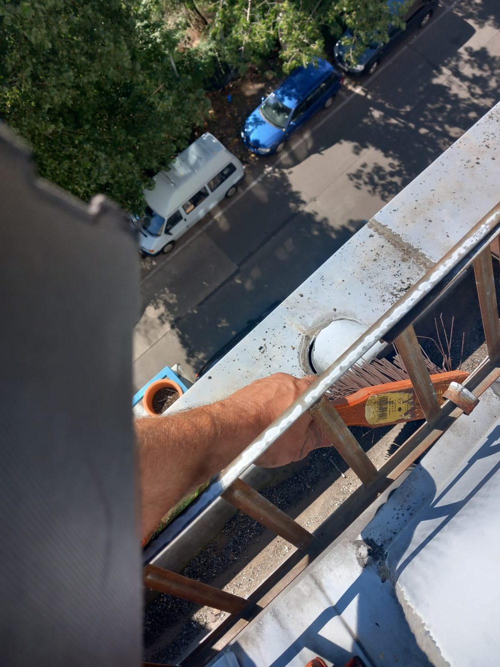 Clearing a gutter and downpipe by hand at height