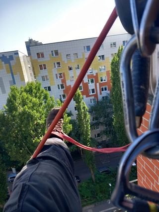 Rope and rigging gear against an apartment block facade