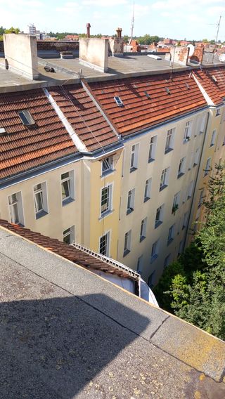 Aerial view along a row of rooftops and chimneys