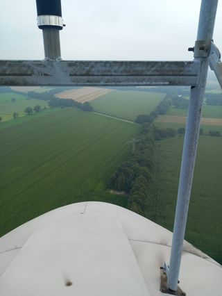 View over farmland from a wind turbine nacelle
